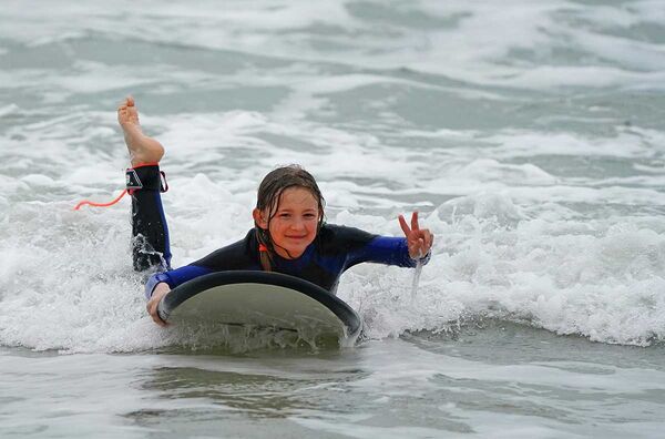 Learn to surf in a surf camp for families