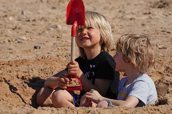 Building sandcastles on the beach at the A-Frame Surfcamp for families