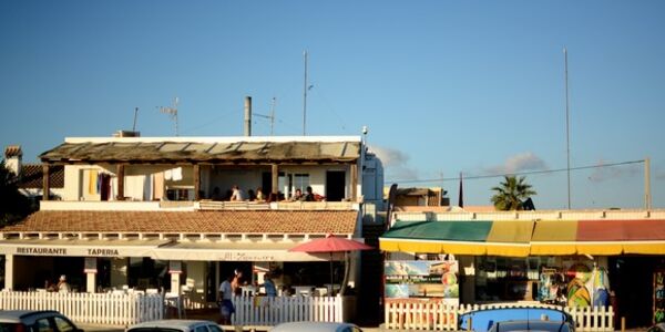 A Frame Surfcamp & Yogacamp above a café and next to a surf shop